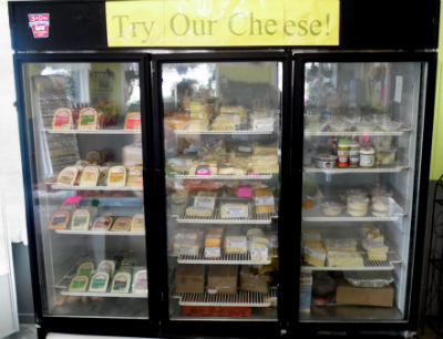 Large cooler filled with specialty cheeses